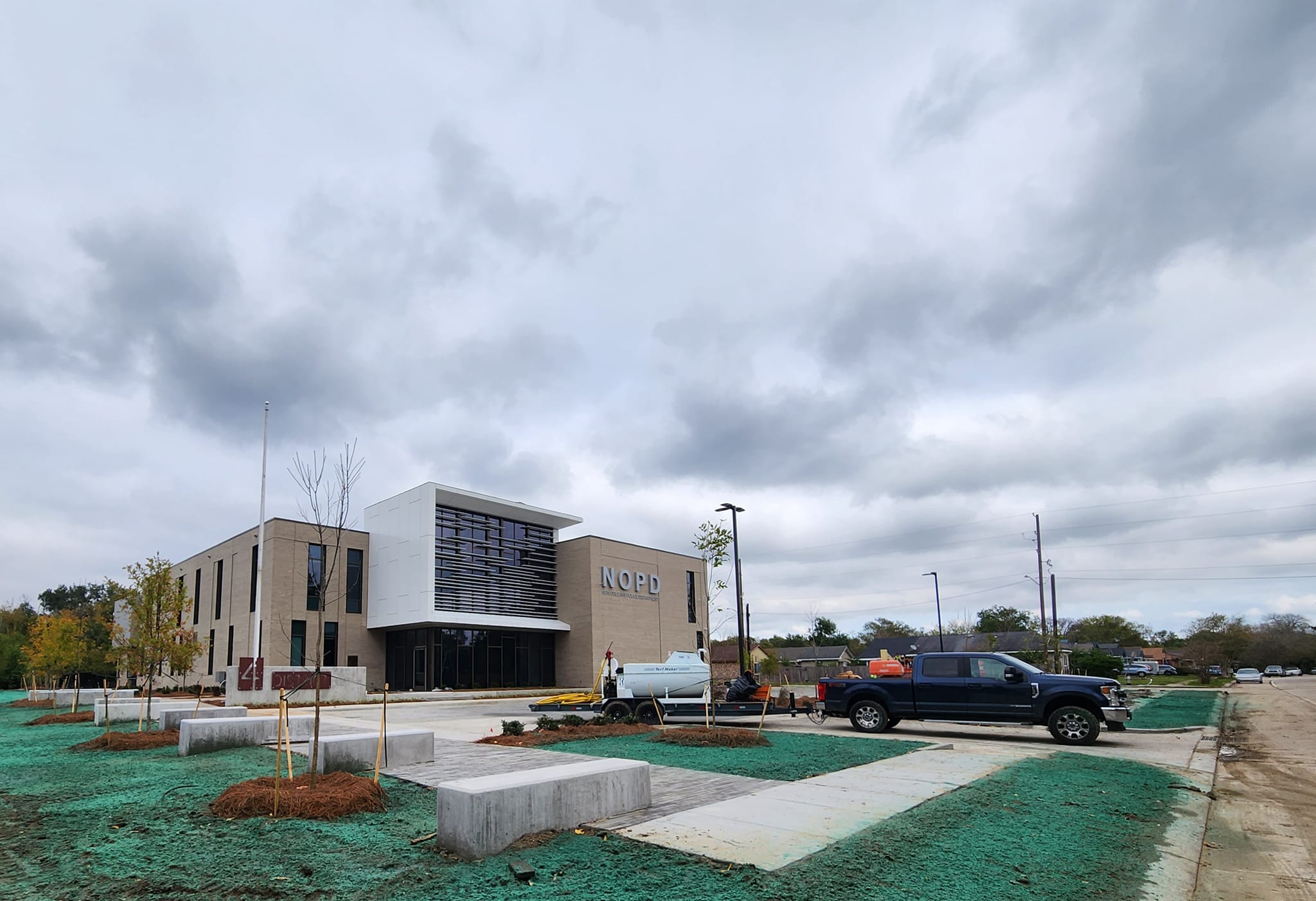 Hydroseeding equipment applying material across a large public facility site